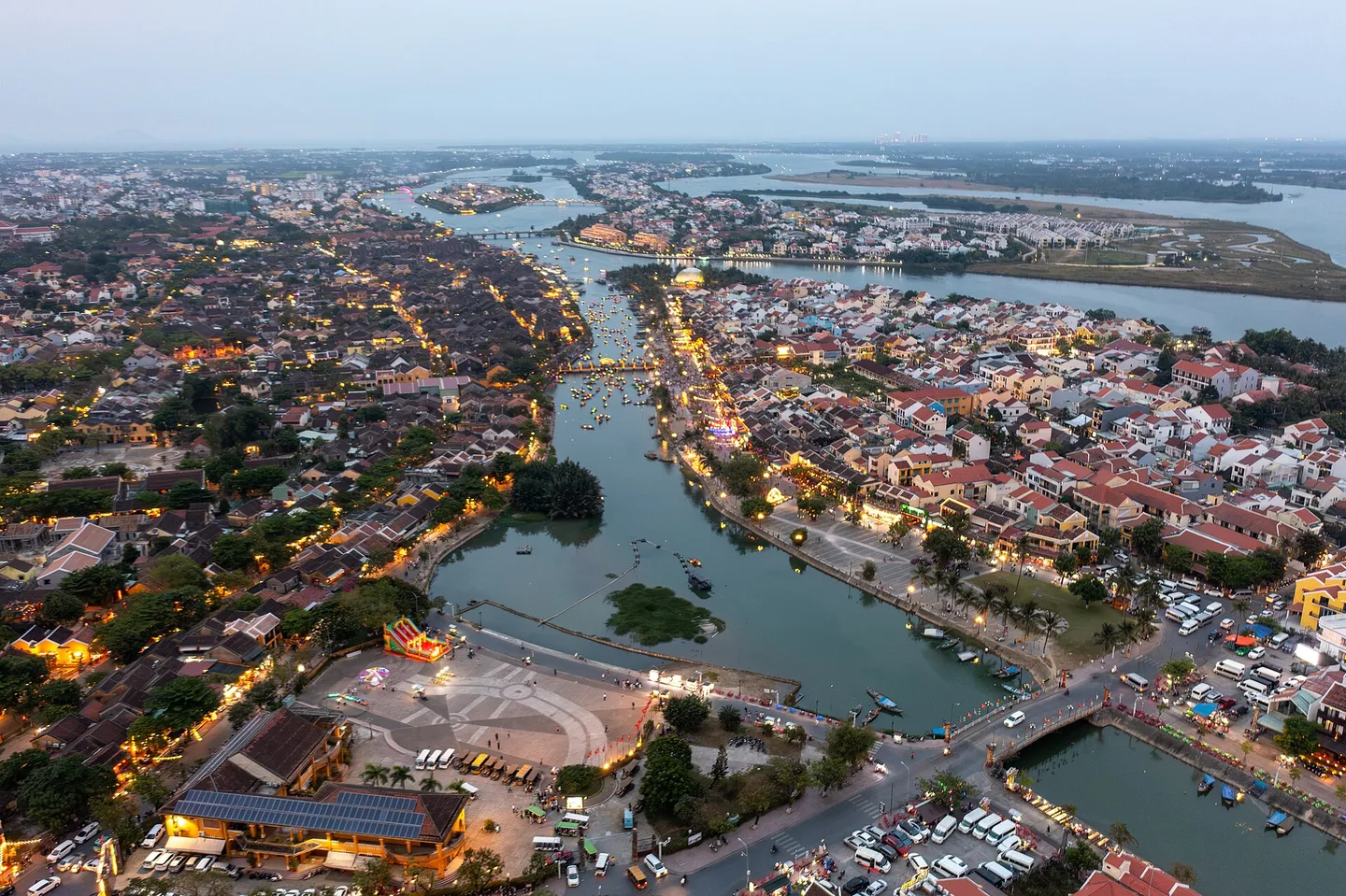 Aerial view of Hoi An's old town along the Thu Bon River at dusk