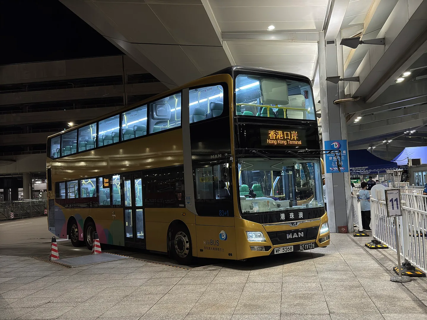Gold HZMB shuttle bus waiting at the Macau Port of the Hong Kong-Zhuhai-Macao Bridge