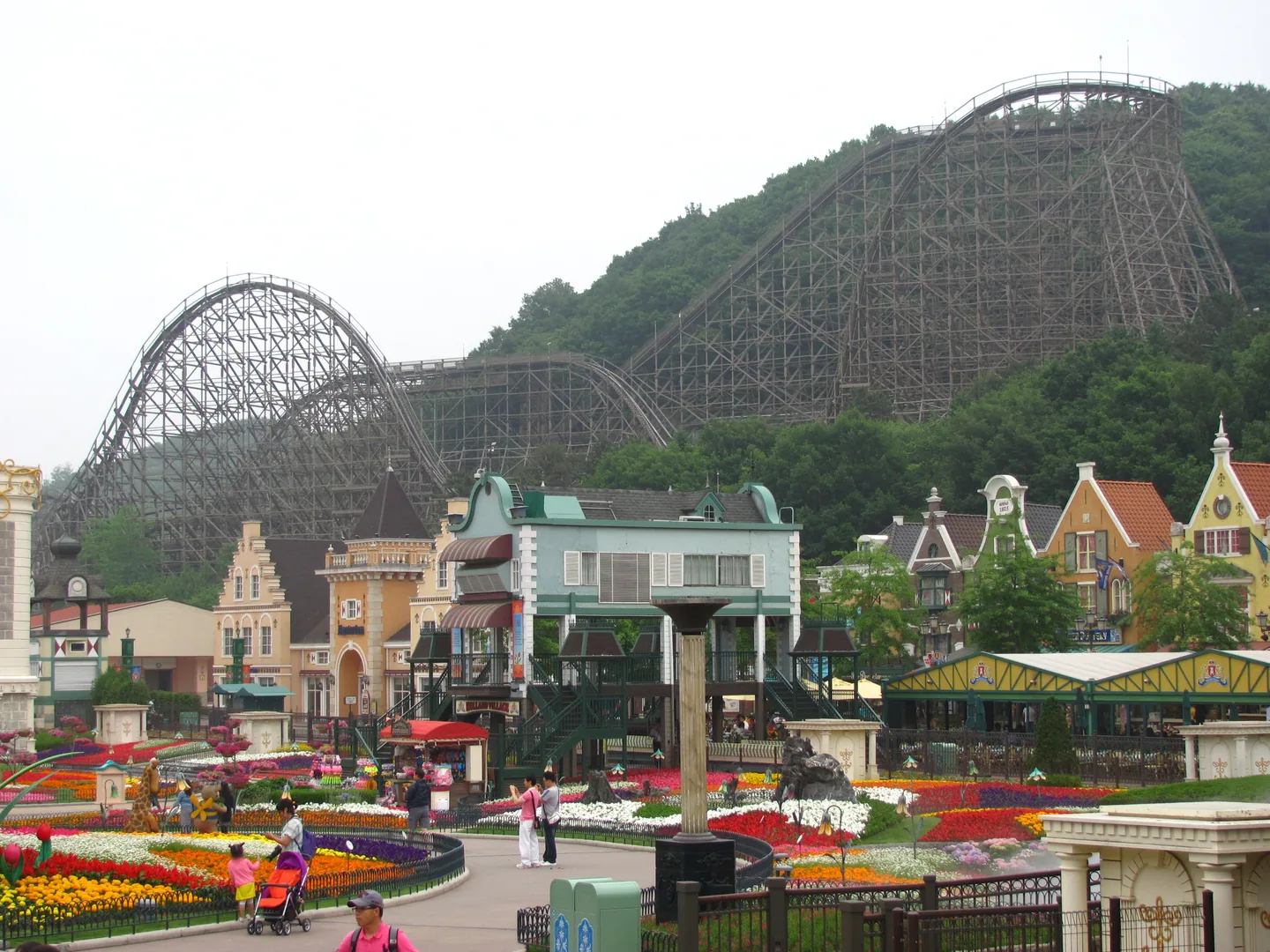 Everland's wooden T Express roller coaster looming over the park's flower gardens and European-style village. — Photo: public domain