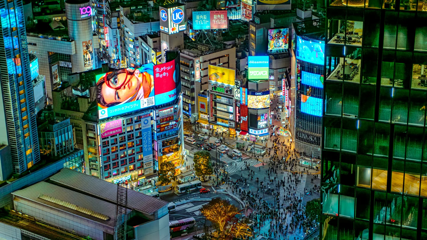 Night view over Shibuya Crossing from a rooftop vantage — the open-air perspective that made Shibuya Sky famous — Photo: David Kernan (CC BY 4.0)