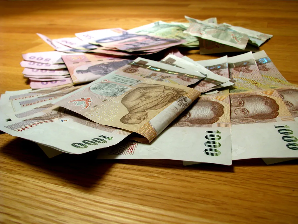 Thai baht banknotes — in Southeast Asia, round the bill up and always tip in the local currency — Photo: Peter Hellberg (CC BY-SA 2.0)
